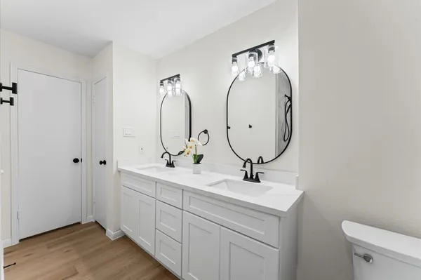 a bathroom with 2 sink and a mirror