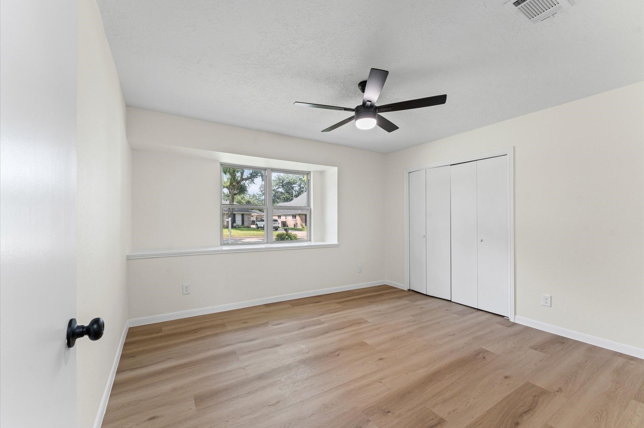 2914 Riata Lane Houston, TX 77043 - Photo 35 of 44 a view of empty room with wooden floor and fan