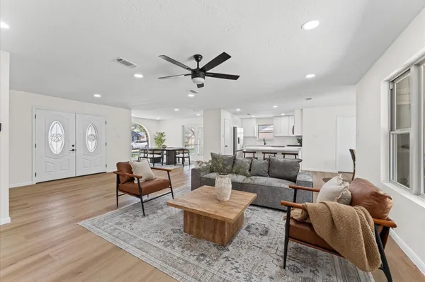a living room with furniture and wooden floor