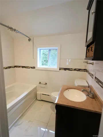 a bathroom with a sink a toilet and bathtub