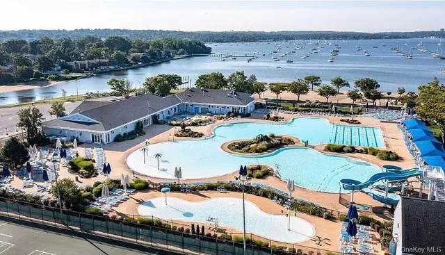 an aerial view of a house with garden space and lake view