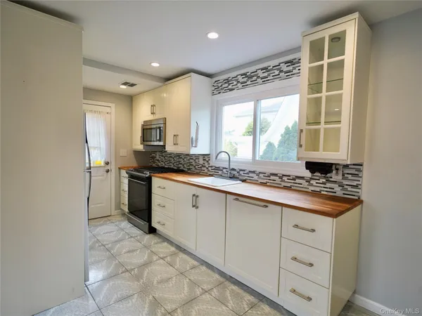 a kitchen with a stove a sink and a refrigerator