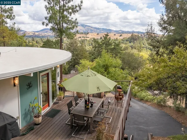 a living room with furniture a flat screen tv and a floor to ceiling window