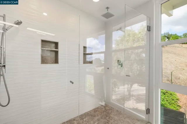 a bedroom with a bed and a large window