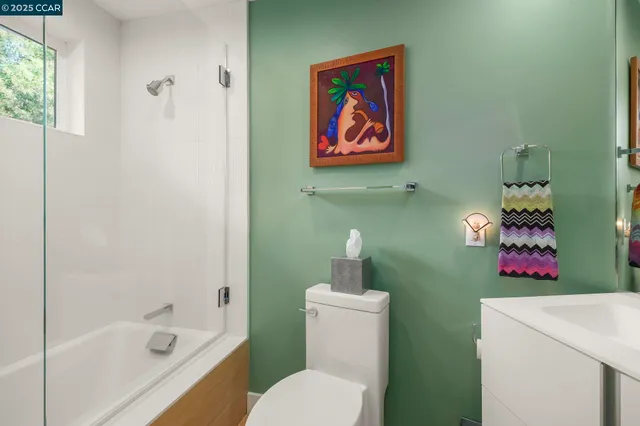 an aerial view of a house with a yard and large tree