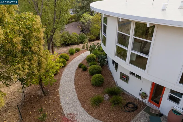 a backyard of a house with a yard and outdoor seating