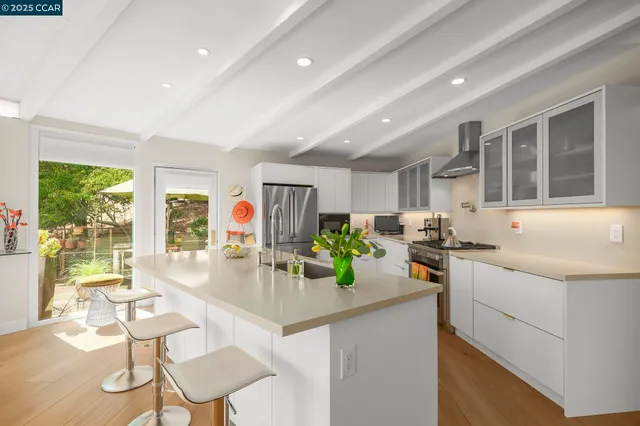 a kitchen with a sink and a stove top oven
