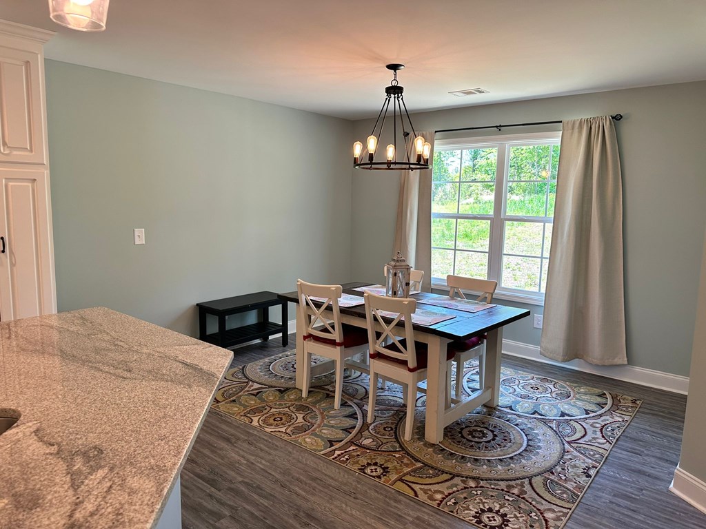 27 Veterans Court Fort Mitchell, AL 36856 - Photo 11 of 31 a view of a dining room with furniture window and wooden floor
