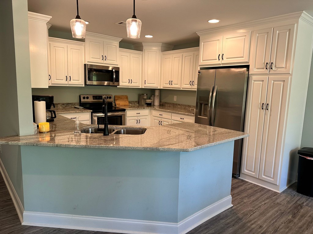 27 Veterans Court Fort Mitchell, AL 36856 - Photo 12 of 31 a kitchen with stainless steel appliances granite countertop a refrigerator a stove a sink and a microwave
