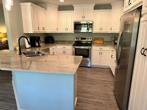 a bedroom with a bed and a refrigerator