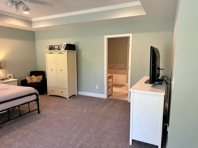 a bed room with a bed and a television