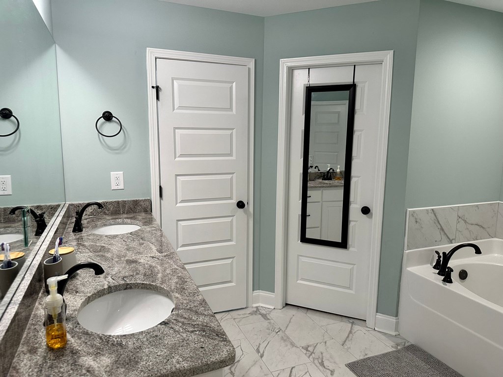 27 Veterans Court Fort Mitchell, AL 36856 - Photo 17 of 31 a bathroom with a sink and a mirror