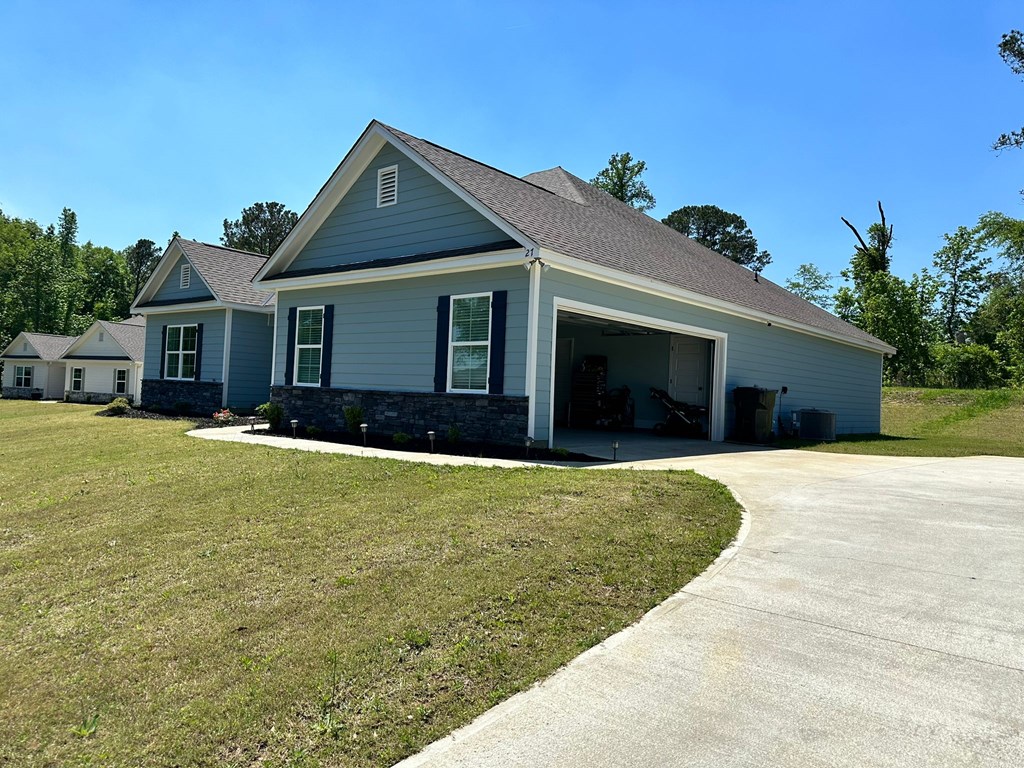 27 Veterans Court Fort Mitchell, AL 36856 - Photo 4 of 31 a front view of a house with a garden