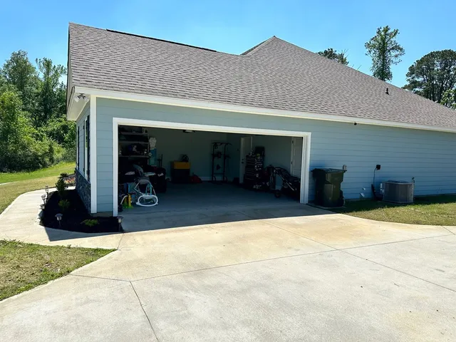 a front view of a house with a chairs and table