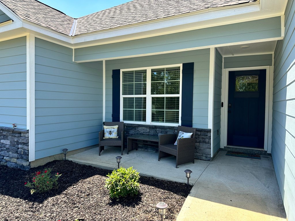 27 Veterans Court Fort Mitchell, AL 36856 - Photo 6 of 31 a front view of a house with a chairs and table