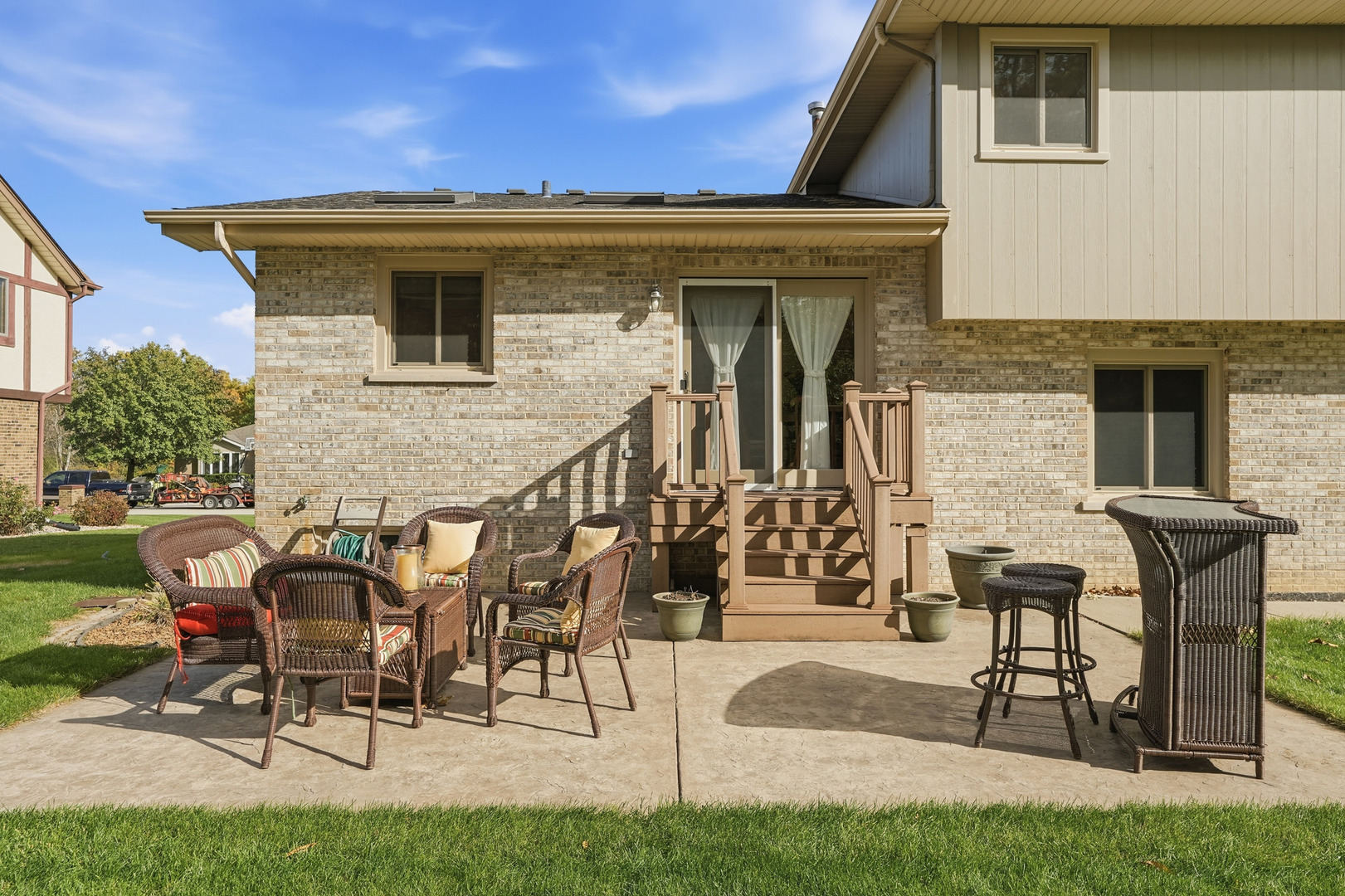 10 Zurich Court Crete, IL 60417 - Photo 36 of 37 a view of a patio with table and chairs with wooden floor and fence