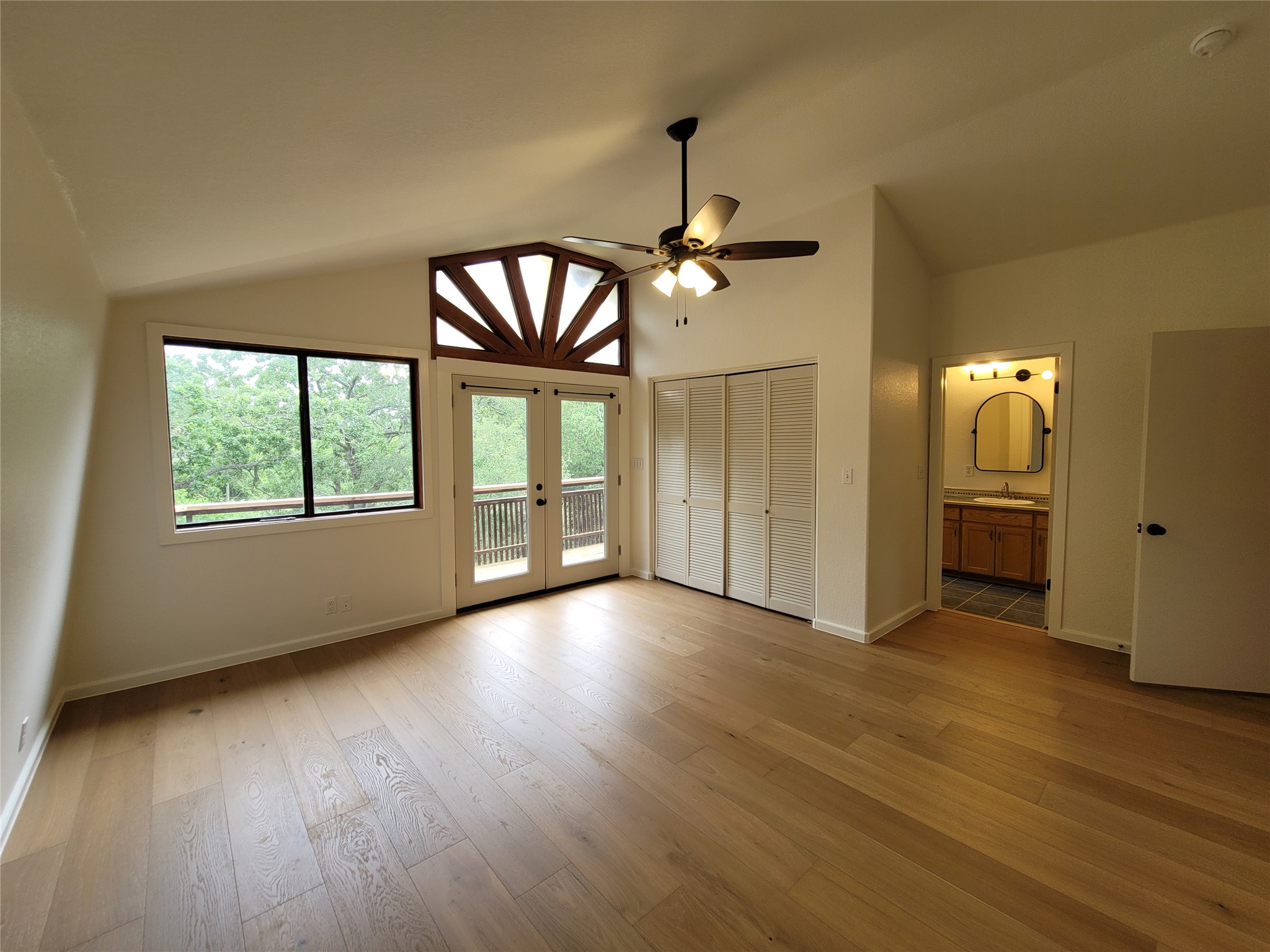 281 Earl Callahan Road, Unit A Cedar Creek, TX 78612 - Photo 19 of 39 wooden floor in an empty room with a window