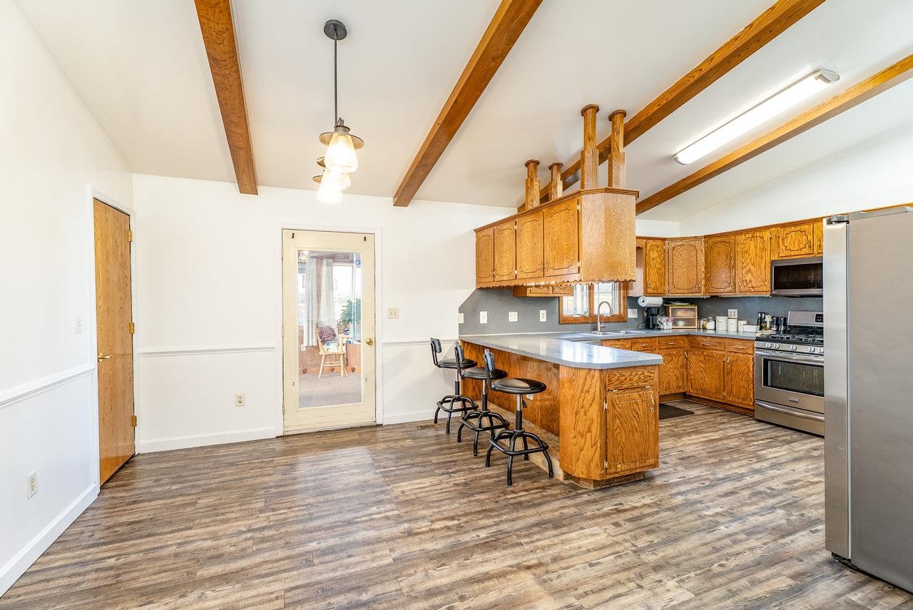 8213 Robinson Road Dayton, VA 22821 - Photo 21 of 75 a kitchen with stainless steel appliances granite countertop a refrigerator a stove a sink dishwasher and white cabinets with wooden floor