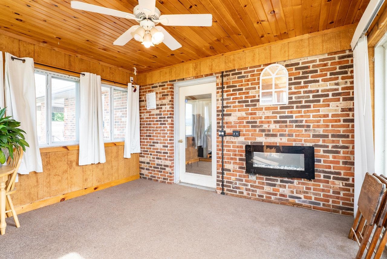 8213 Robinson Road Dayton, VA 22821 - Photo 24 of 75 a view of an empty room with a fireplace and a window