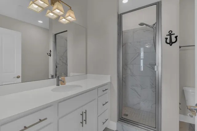 a bathroom with a shower sink and mirror
