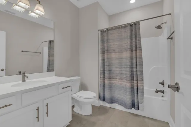 an empty room with closet and windows