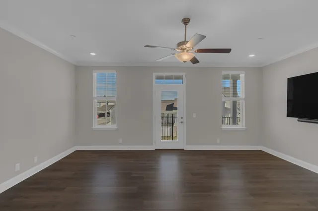 a view of wooden floor and windows in a room