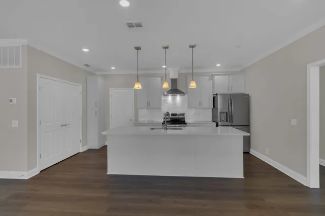 a view of kitchen with stainless steel appliances granite countertop living room and couches