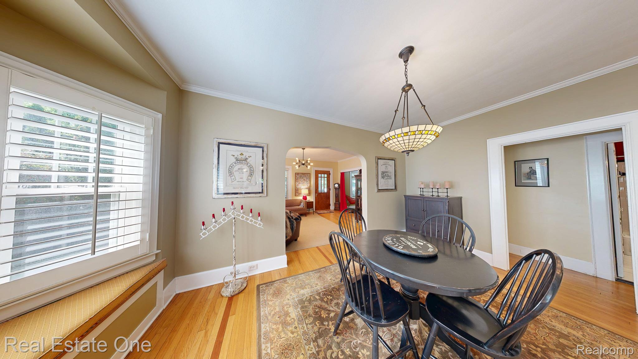 410 West 4th Street Rochester, MI 48307 - Photo 9 of 33 Dining area with hardwood flooring, crown molding, and a Tiffany-style pendant light fixture