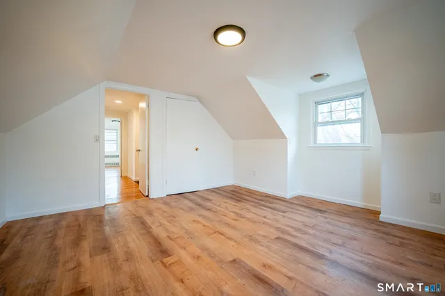 a bathroom with a granite countertop toilet a sink and a bathtub