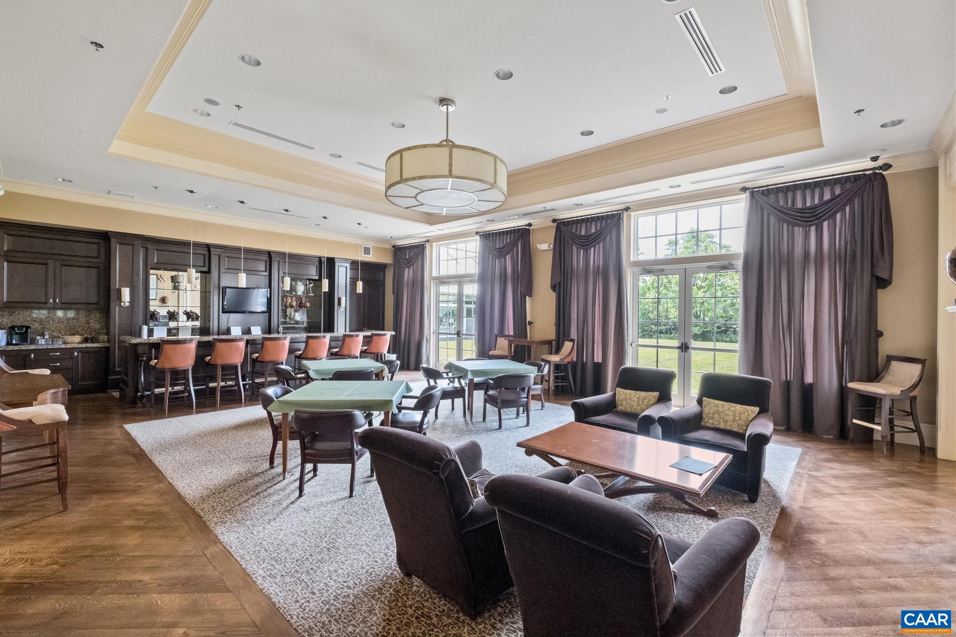 124 Stodghill Drive Ruckersville, VA 22968 - Photo 50 of 58 a living room with patio furniture and a chandelier