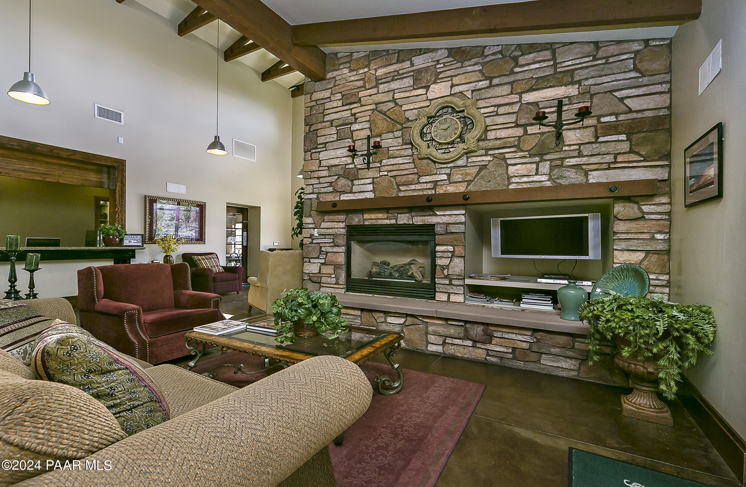 1195 Rigo Ranch Road Prescott Valley, AZ 86314 - Photo 24 of 65 a living room with furniture flat screen tv and a fireplace