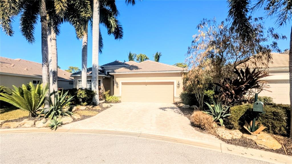 124 Turquoise Lane Osprey, FL 34229 - Photo 2 of 48 a view of a backyard of a house with a patio