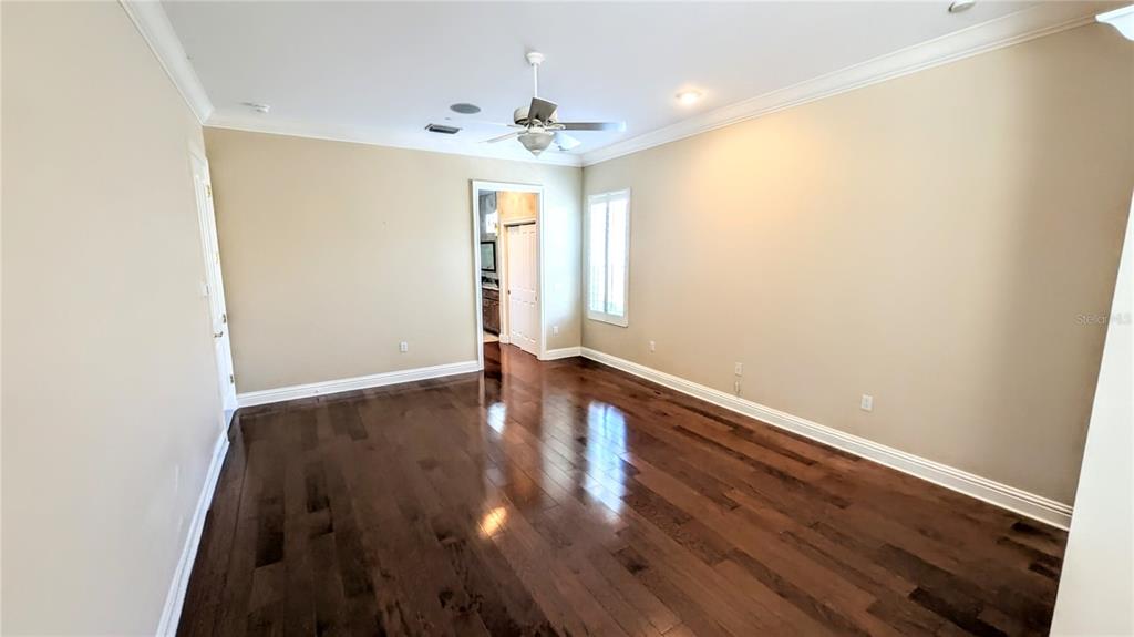124 Turquoise Lane Osprey, FL 34229 - Photo 24 of 48 an empty room with wooden floor and windows