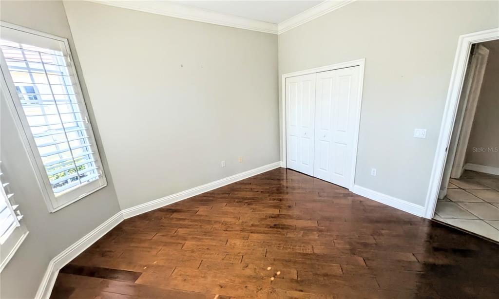 124 Turquoise Lane Osprey, FL 34229 - Photo 37 of 48 a view of empty room with wooden floor and fan