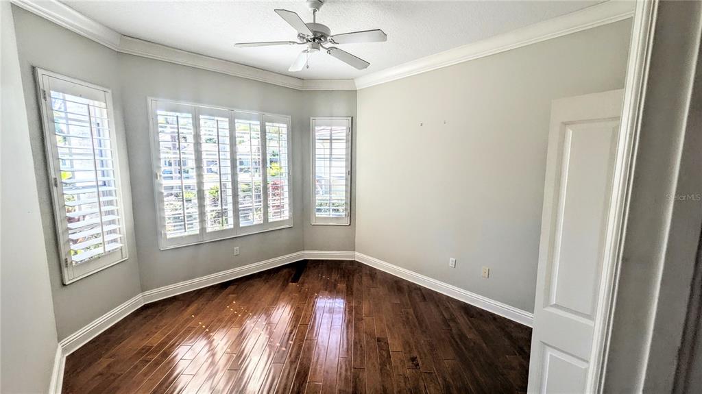 124 Turquoise Lane Osprey, FL 34229 - Photo 38 of 48 a view of empty room with wooden floor and fan