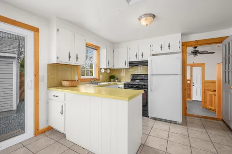 a kitchen with a refrigerator a stove a sink and a cabinets
