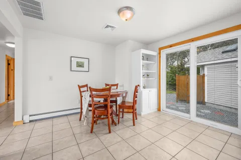a dining room with furniture and window