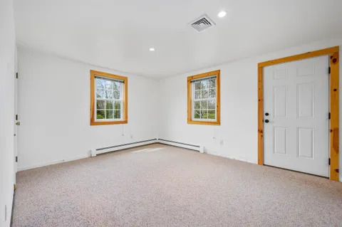 an empty room with windows and closet