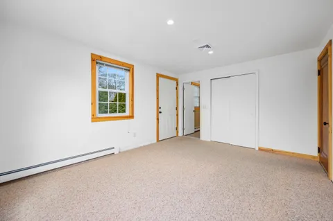 an empty room with a empty space and windows
