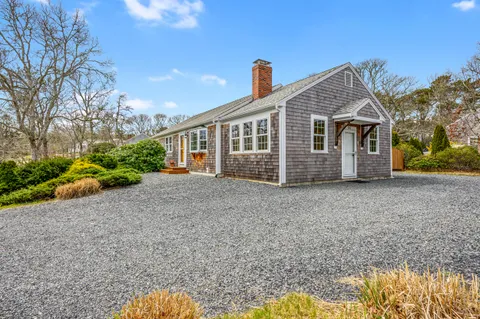 a view of a house with porch and garden