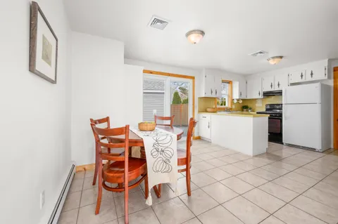 a kitchen with granite countertop cabinets and chairs