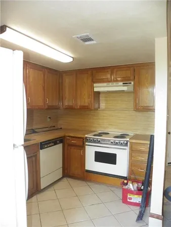 a kitchen with stainless steel appliances granite countertop a stove and a sink