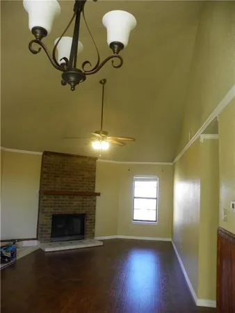 a view of empty room with window and fireplace