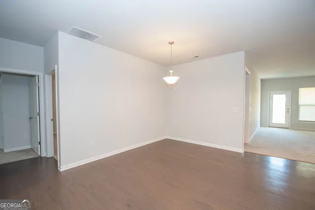 a kitchen with stainless steel appliances granite countertop a sink a stove and a wooden floors