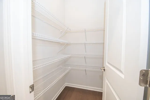 an empty room with a window and a ceiling fan