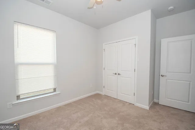 a bathroom with a sink a toilet a mirror and shower