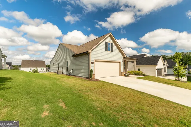 a view of a house with a yard and garage