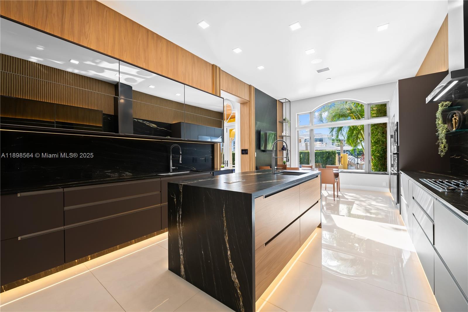 1530 Island Boulevard Aventura, FL 33160 - Photo 18 of 99 a kitchen with stainless steel appliances kitchen island granite countertop a sink and cabinets