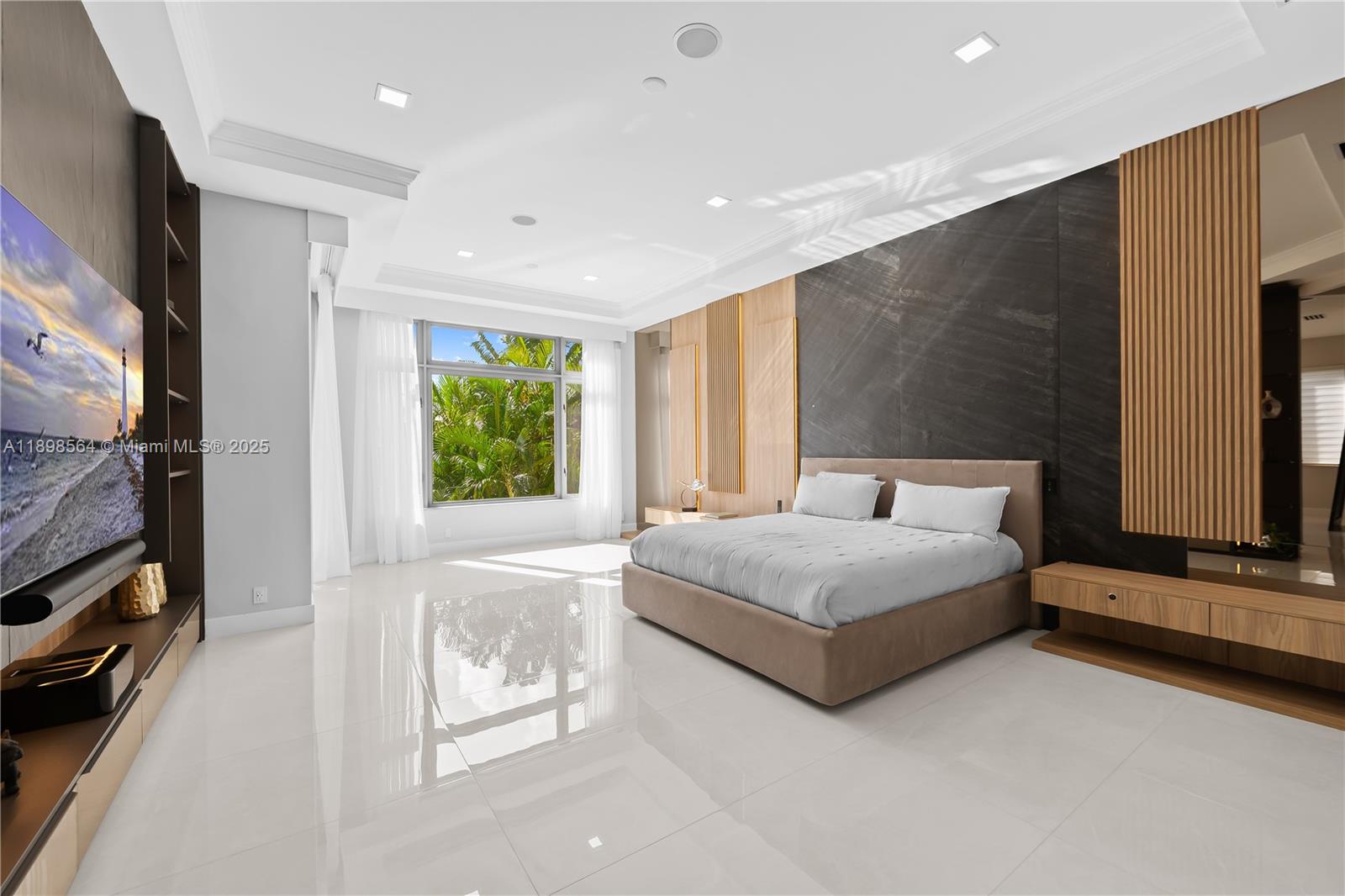 1530 Island Boulevard Aventura, FL 33160 - Photo 37 of 99 a spacious bedroom with a large bed and a flat tv screen on dresser