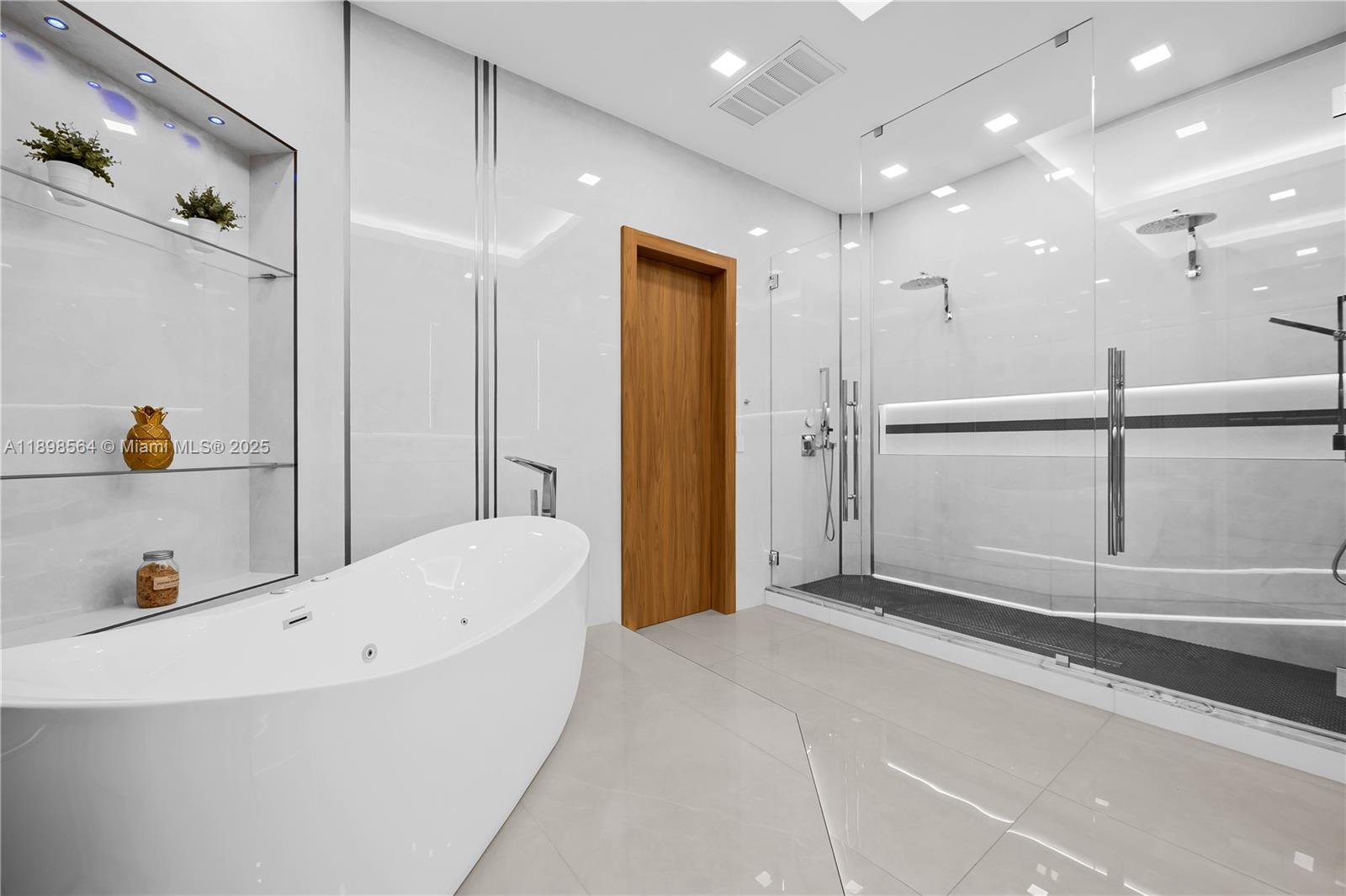 1530 Island Boulevard Aventura, FL 33160 - Photo 43 of 99 a bathroom with a tub and a shower
